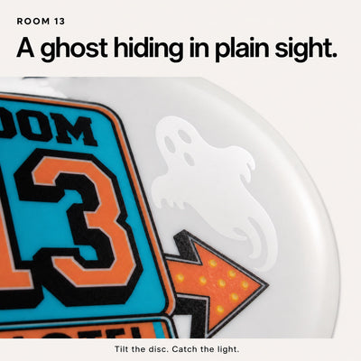 Close-up of the smooth hidden ghost catching the light beside the Room 13 motel sign.