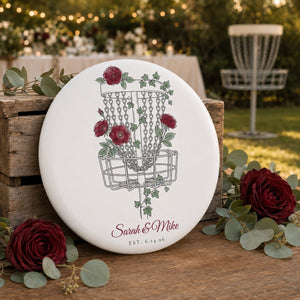 Floral disc golf disc lifestyle photo — rose and ivy basket design with personalized names