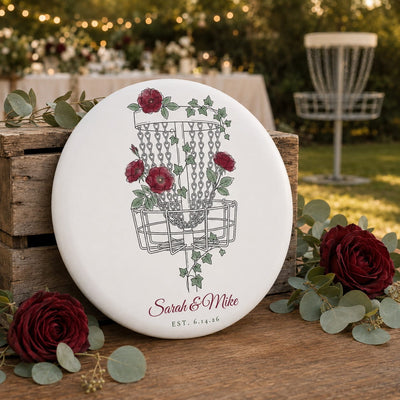 Floral disc golf disc lifestyle photo — rose and ivy basket design with personalized names
