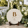 Best man personalized disc golf disc with monogram initial, name and wedding date on a stand at an outdoor ceremony