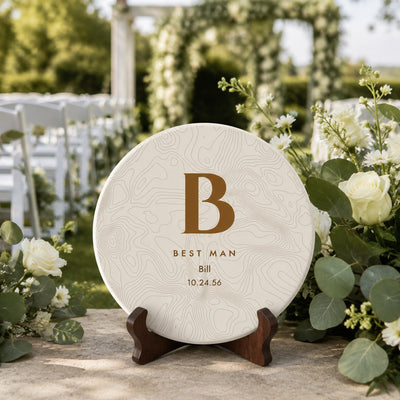 Best man personalized disc golf disc with monogram initial, name and wedding date on a stand at an outdoor ceremony