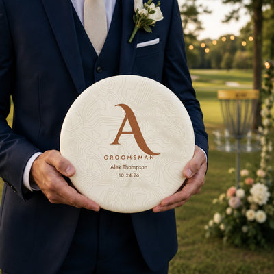 Personalized groomsman disc golf disc with topographic monogram design — initial, title, name, and wedding date