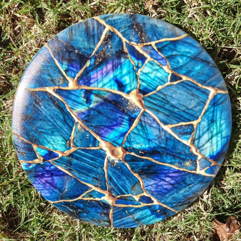 Real Kintsugi disc golf disc photographed on grass in natural light