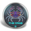 Decorative button with a colorful crab design and 'The Crab' text on a dark background