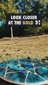Video of the Kintsugi disc golf disc with the gloss gold veins catching sunlight
